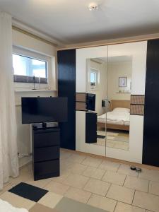 Habitación con espejo y dormitorio con cama. en Prinzenhof "Lieblingsplatz" App 27 inkl WLAN, en Grömitz