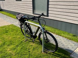 a bike parked in the grass next to a building at Ostseecamp Ferienhaus "Horizont" in Scharbeutz