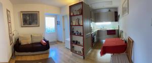 a living room with a couch and a kitchen at MiniLevico in Levico Terme