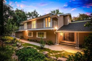 a house with a balcony and a yard at Pacific Dreams at Woodland Hills - 8 BR with Pool & Hot Tub in Woodland Hills