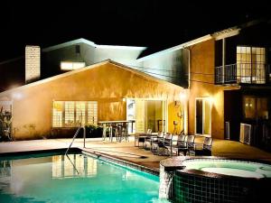 a house with a swimming pool in front of a house at Pacific Dreams at Woodland Hills - 8 BR with Pool & Hot Tub in Woodland Hills