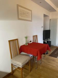 a dining room table with a red table cloth on it at MiniLevico in Levico Terme