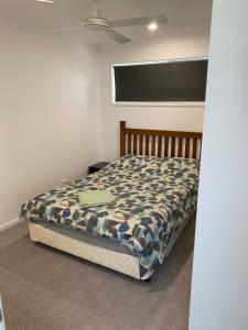 a bedroom with a bed in a room at 2BD Family or Couple Guesthouse Upstairs near Turf club, HOTA in Bundall in Gold Coast +10 photos