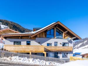 a house in the mountains with a wooden fence at Stacherl in Rauris