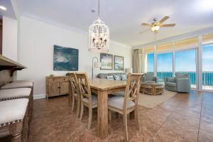 a dining room with a table and chairs at Phoenix Gulf Shores 803 condo in Gulf Shores