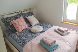 a bed with two towels and pillows on it at Holiday Home in Sieciemin near Baltic Coast in Sieciemin