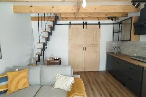 a living room with a couch and a staircase at Holiday Home in Sieciemin near Baltic Coast in Sieciemin