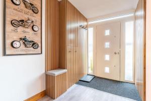 a hallway with a wooden wall with motorcycles on it at Triumph House in Hinckley
