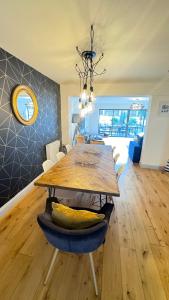 a dining room with a wooden table and a dining roomiasm at Tregenna House - St Ives, A Beautiful Newly Refurbished 4 Bedroom Family Town House With Alfresco Dining Garden and Private Parking Spaces in St Ives
