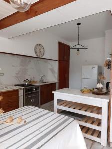 a kitchen with a white counter and a sink at Casa alquiler temporario miramar in Miramar