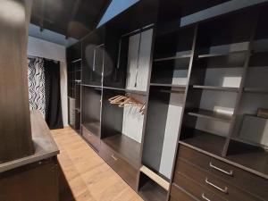 a large kitchen with black cabinets and shelves at Casa alquiler temporario miramar in Miramar +17 photos