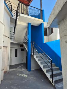 a staircase in a building with a blue wall at Cómodo y moderno loft Tec de Mty in Monterrey