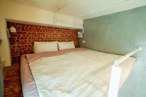 A bed or beds in a room at Funtime Hostel