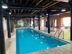 a large swimming pool with blue water in a building at Melbourne Riverside Retreat in Melbourne