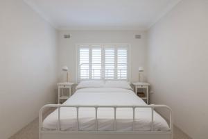 シドニーにあるStunning Maroubra Beachview Apt with Parkingの窓付きの白い部屋の白いベッド