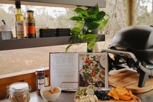 a table with a helmet and a plate of food at Riverbank Glamping in Boonarga