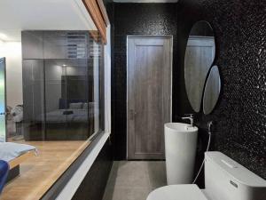 a bathroom with a toilet and a sink and a mirror at Cy sea villa 3 in Da Nang +8 photos