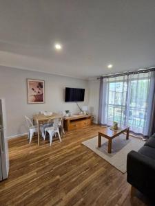 a living room with a table and a television at Oasis Mandurah Resort in Mandurah