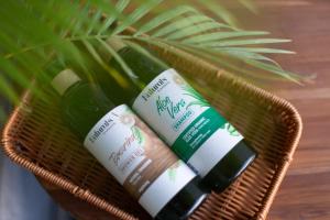 three bottles in a basket on a table at Comfy Corner Hotel in Chiang Mai