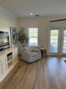 a living room with a couch and a tv at Waterfront luxury Villa 19 with sunset views and boat slip townhouse in Marathon