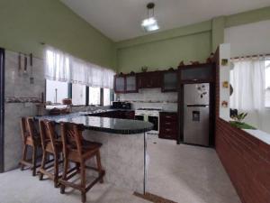a large kitchen with a table and chairs in it at Quinta Xcaret in Cabudare