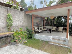 a patio with chairs and tables in a building at Kataleya Villa, Punclut 4BR in Bongkar 2