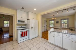 a kitchen with white cabinets and a white refrigerator at Harrisonburg Hidden Gem Across from JMU & Hotspots in Harrisonburg