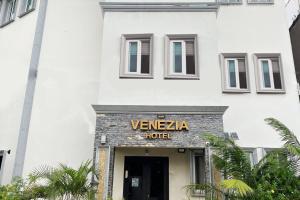a white building with a sign that reads venza hotel at Venezia Suites Hotel Iloilo in Iloilo City