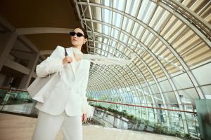 a woman in a white suit in a building at Marina Bay Sands in Singapore