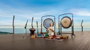 a man sitting on a table with food on a deck at Marina Bay Sands in Singapore