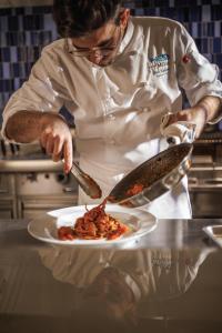 a chef in a kitchen preparing a plate of food at Marina Bay Sands in Singapore