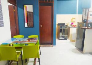 a kitchen with a table and chairs and a blue wall at Apartamento centro historico 209 in Cartagena de Indias