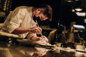 a chef preparing food in a restaurant kitchen at Marina Bay Sands in Singapore