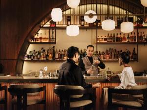 a group of people sitting at a bar at Marina Bay Sands in Singapore