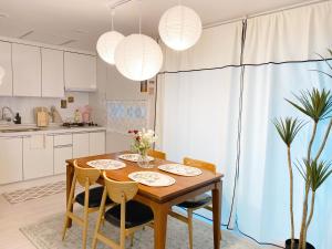 a kitchen with a wooden table with chairs and a dining room at Sha lala stay in Seoul +33 photos