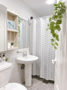 a bathroom with a sink and a shower curtain at Sha lala stay in Seoul
