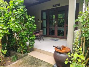 a front door of a house with a plant at Bang Po Hut in Ban Bang Po