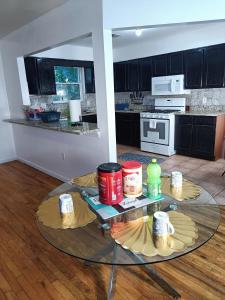 a kitchen with a glass table in a room at Fada Guest House - 38 Yates Ave Newark in Newark