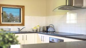 a kitchen with a sink and a window at Barkeldine Farm Country Retreat in Bucca-Wauka +13 photos
