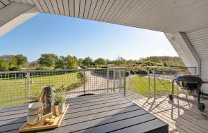 a balcony with a view of a field and a grill at Beautiful Apartment In Glesborg in Glesborg