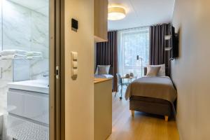 Postel nebo postele na pokoji v ubytování Hessnery Hotel + 37 fotografií