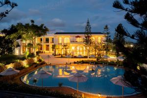 a view of a hotel with a pool and umbrellas at Edensee Kega Beach Resort in Ke Ga