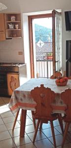 a kitchen with a table and a view of a balcony at Al Portec in Vezzano +15 photos