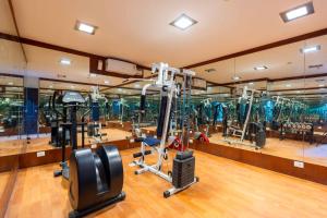 a gym with a lot of treadmills and machines at Treebo Ivory White Inn in Bengaluru