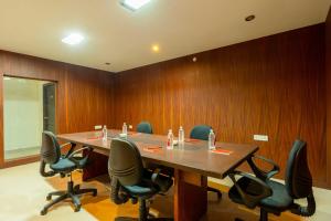 a conference room with a long table and chairs at Treebo Ivory White Inn in Bengaluru