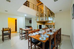 a dining room with a long table and chairs at Treebo Ivory White Inn in Bengaluru
