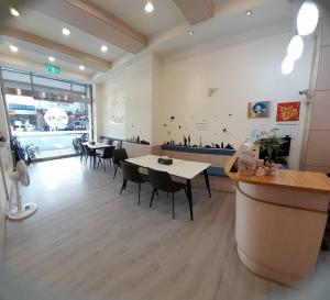 a restaurant with tables and chairs in a room at 飛日月漫旅Flying Sun & Moon in Yuchi