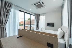 a bedroom with a bed and a large window at Peaceful Paradise in Saiyuan Villa V147 in Ban Saiyuan (1)