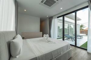 a bedroom with a white bed and a large window at Peaceful Paradise in Saiyuan Villa V147 in Ban Saiyuan (1) +46 photos