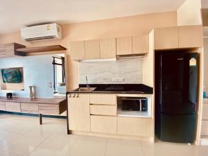 a kitchen with a sink and a stove top oven at Stunning 60 sqm Studio at NaiHarn Beach Condo, Walk to Beach, Your Tropical Retreat! in Rawai Beach